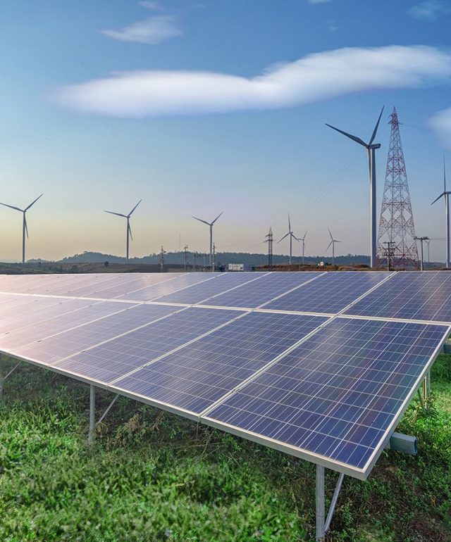 renewable-energy-solar-panels-wind-turbines-green-grass-blue-sky